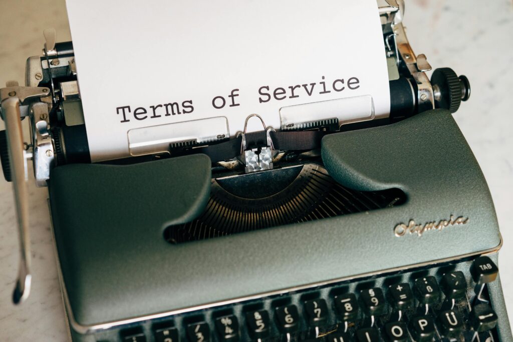 Close-up of a vintage typewriter printing 'Terms of Service' on paper, ideal for legal and business themes. - Terms and Conditions