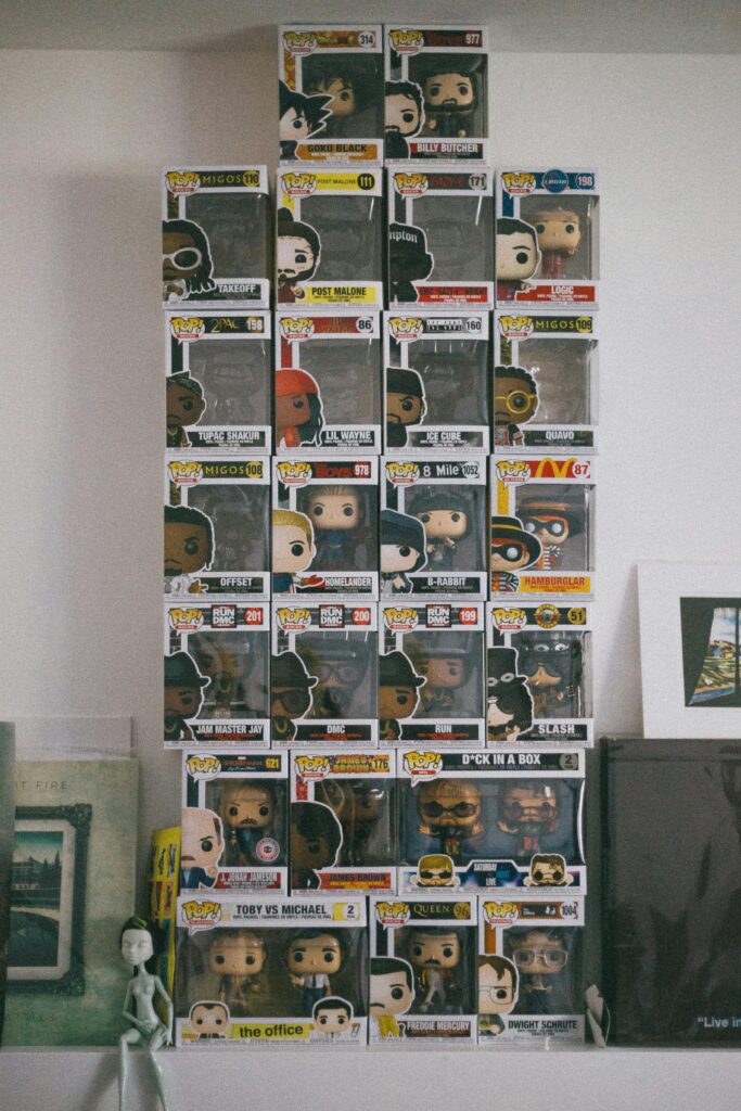 Stacked Funko Pop figurines on a display shelf in a room interior.
